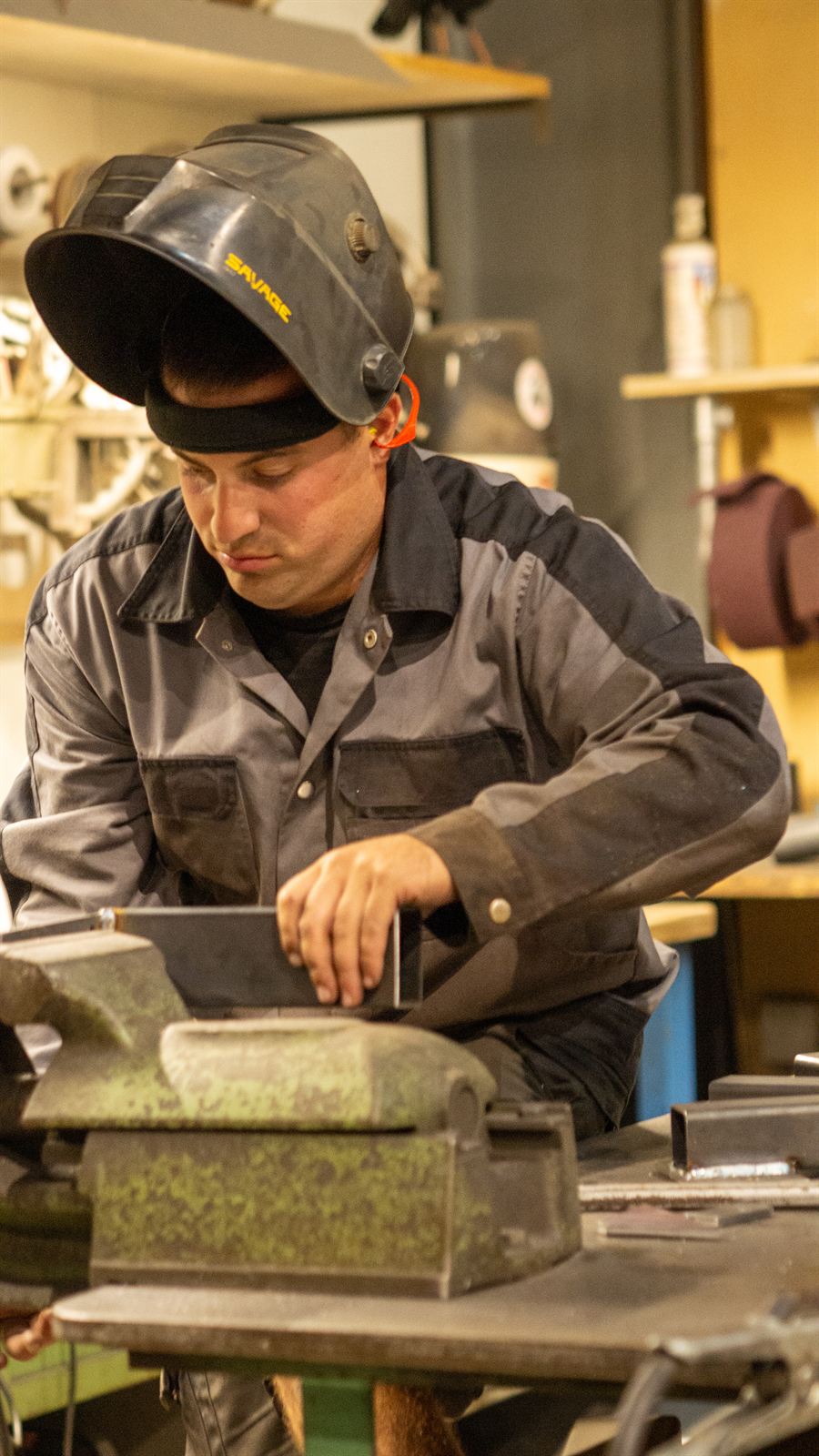 artmodern-Mitarbeiter bei der Arbeit am Schraubstock in der Werkstatt